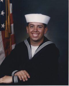 Adam Dince as a young sailor in his United States Navy dress uniform